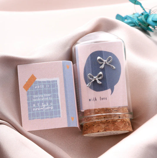 Attic Creations Little Note Curled Bow Earrings Silver